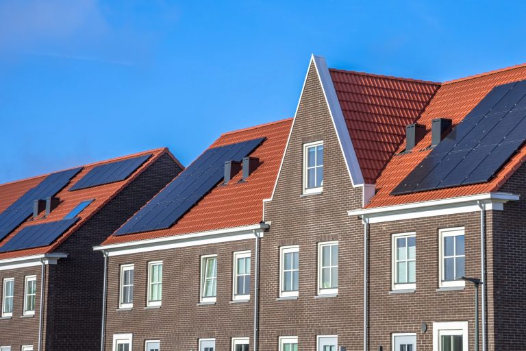 close-up-of-modern-row-houses-with-solar-panels-2021-08-26-16-38-04-utc
